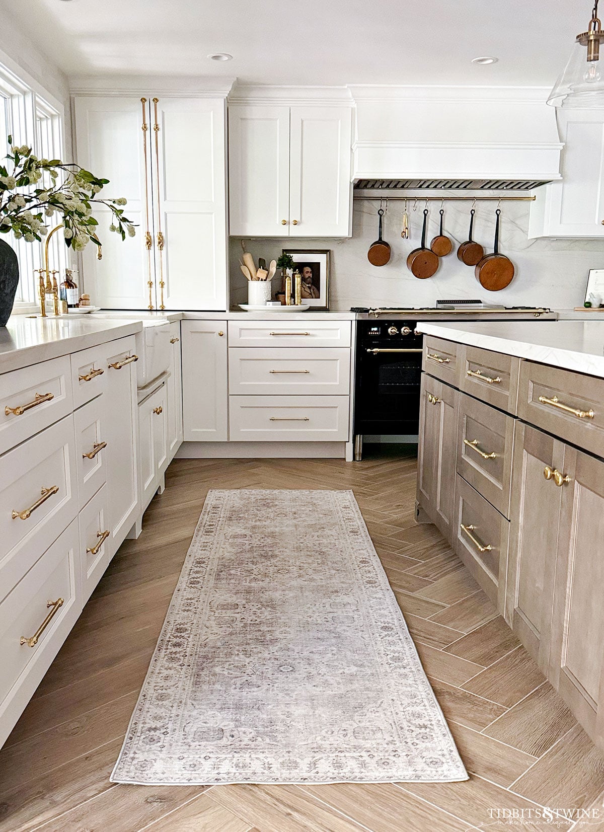 White kitchen cabinets with wooden island after a remodel