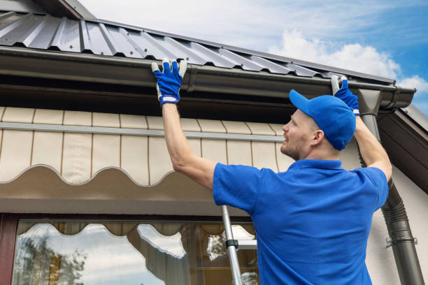 Roofer installing a new roof and gutter system